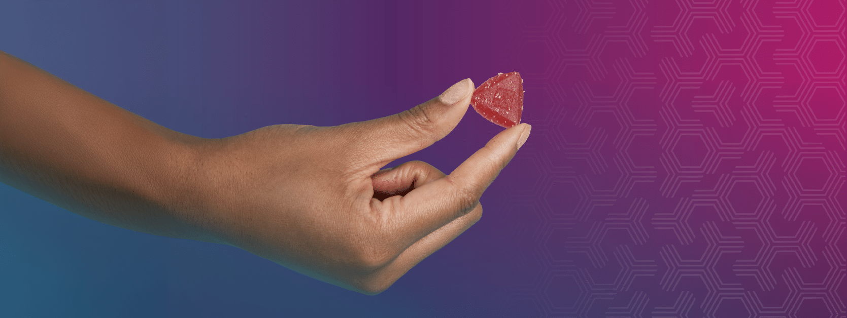 A hand holding a Quick Relief Gummy.